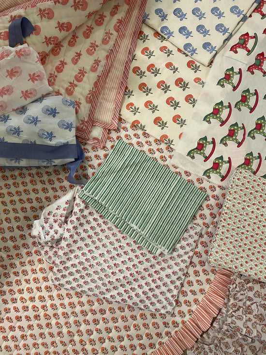 Various bespoke patterned quilt textiles folded 