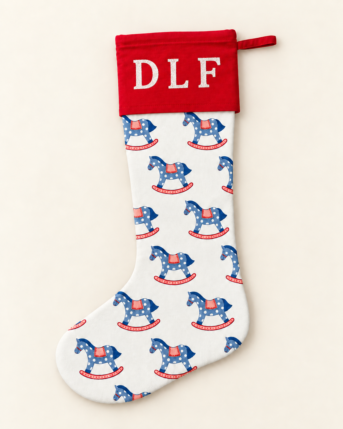 Personalised blue rocking horse Christmas stocking with red cuff and white embroidered DLF initials.