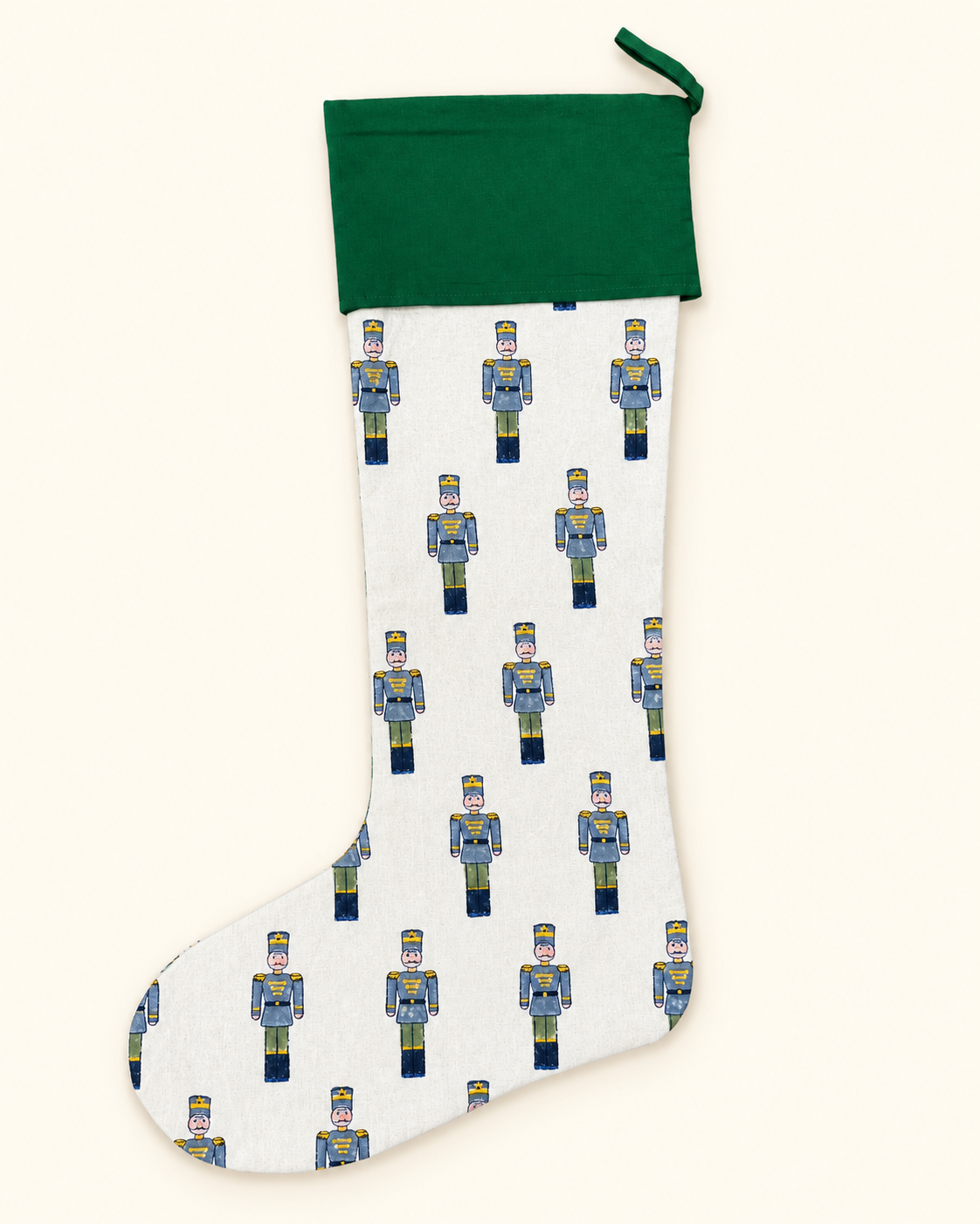 Green cuff Christmas stocking with hand block printed toy soldier design by Kapara London.