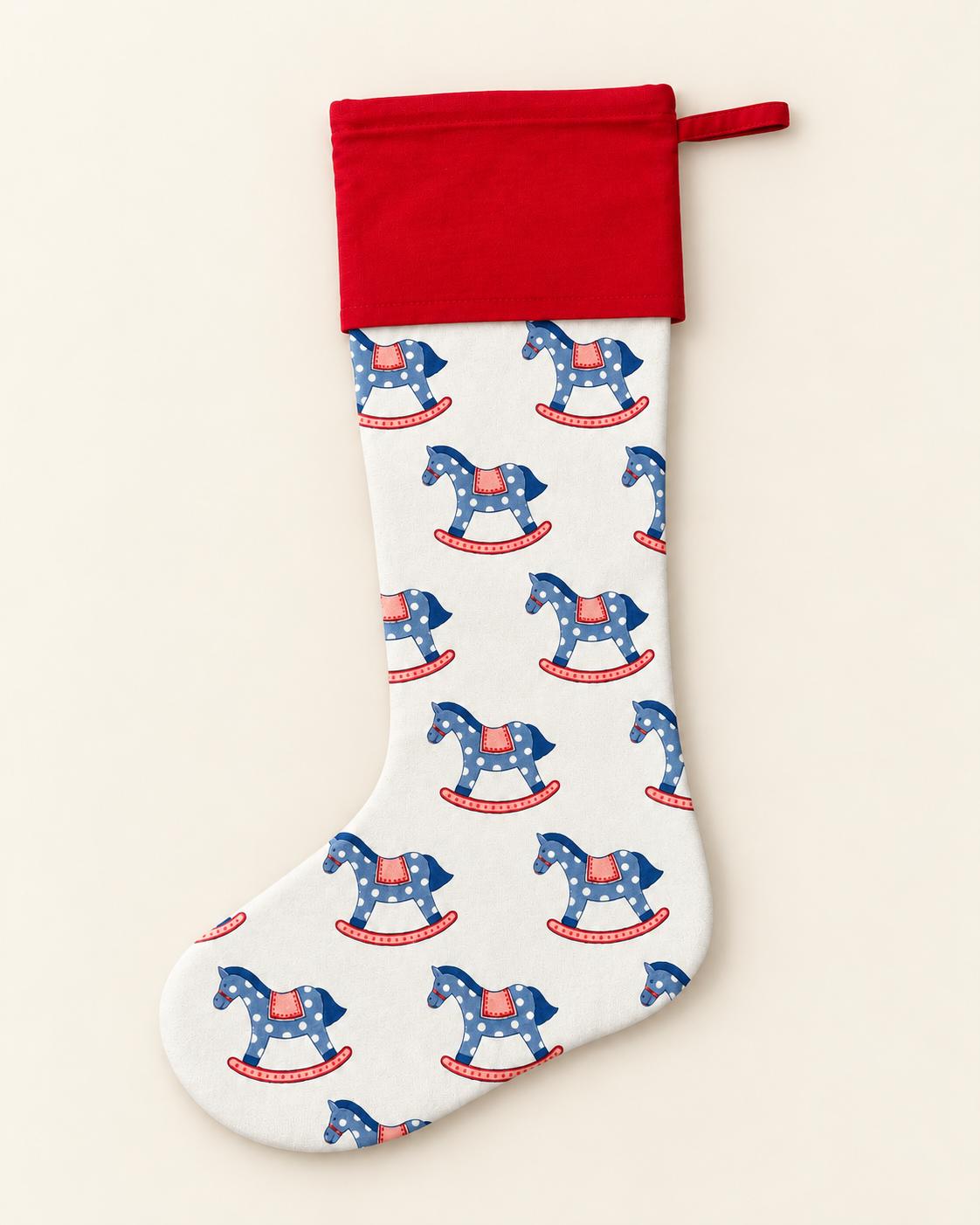 Blue and pink rocking horse Christmas stocking with a contrasting red cotton cuff, hand block printed by Kapara London.