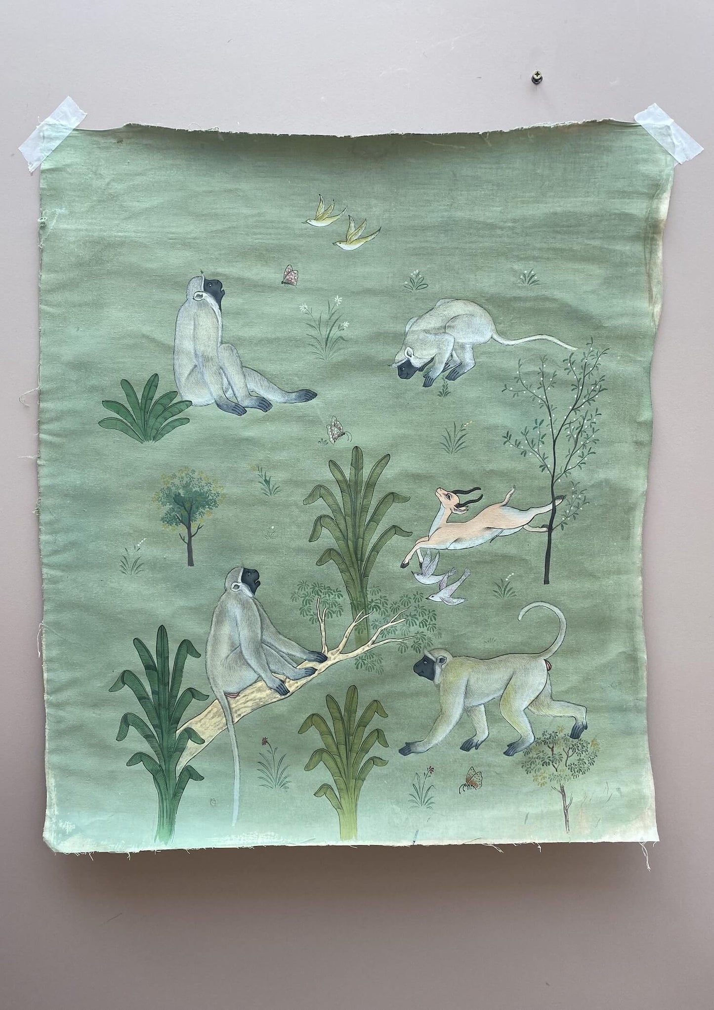 Pale green bespoke painting depicting monkeys, birds and antilopes as well as vegetation