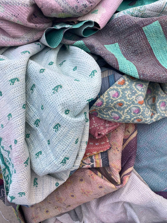 Various pink and turquoise printed textiles